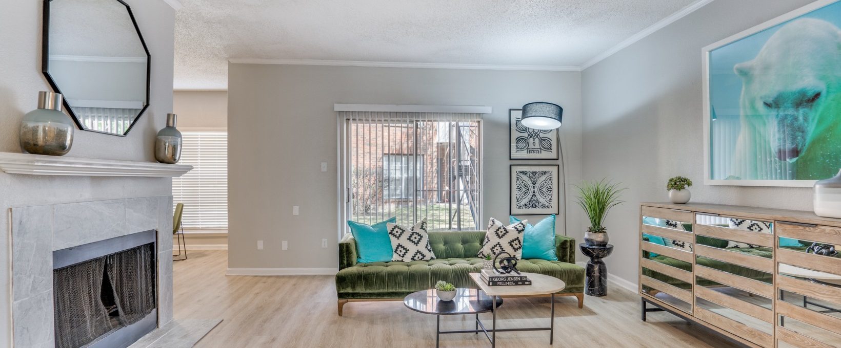 a living room with a fireplace and a couch at The  Hathaway at Willow Bend