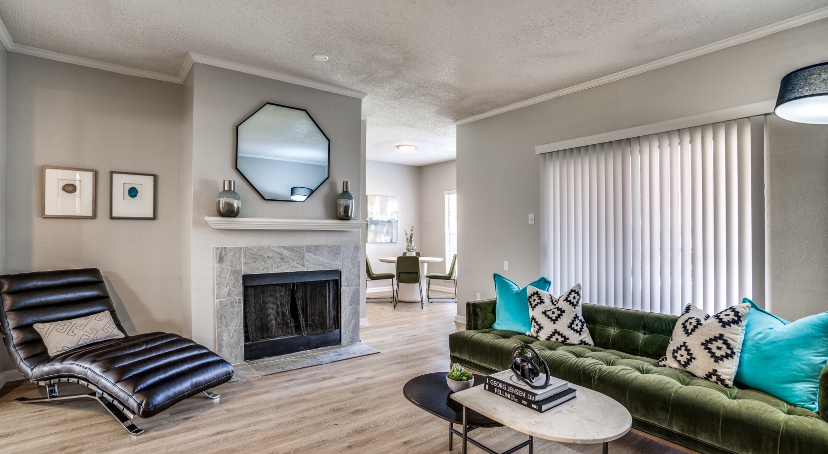 a living room with a fireplace and green couch at The  Hathaway at Willow Bend