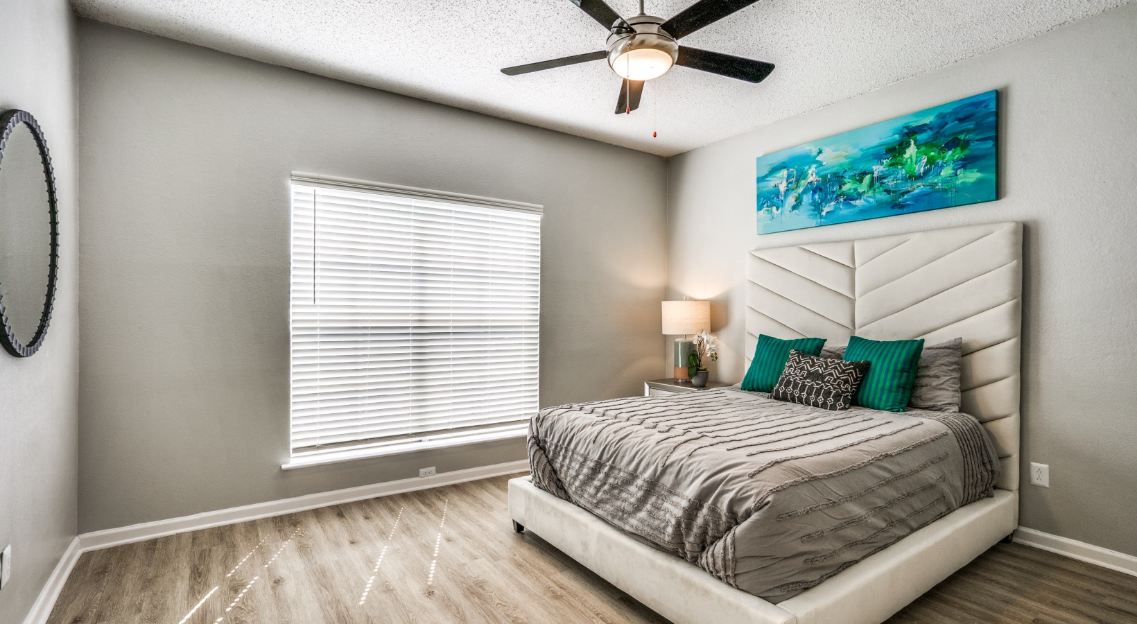 a bedroom with a ceiling fan and hardwood floors at The  Hathaway at Willow Bend
