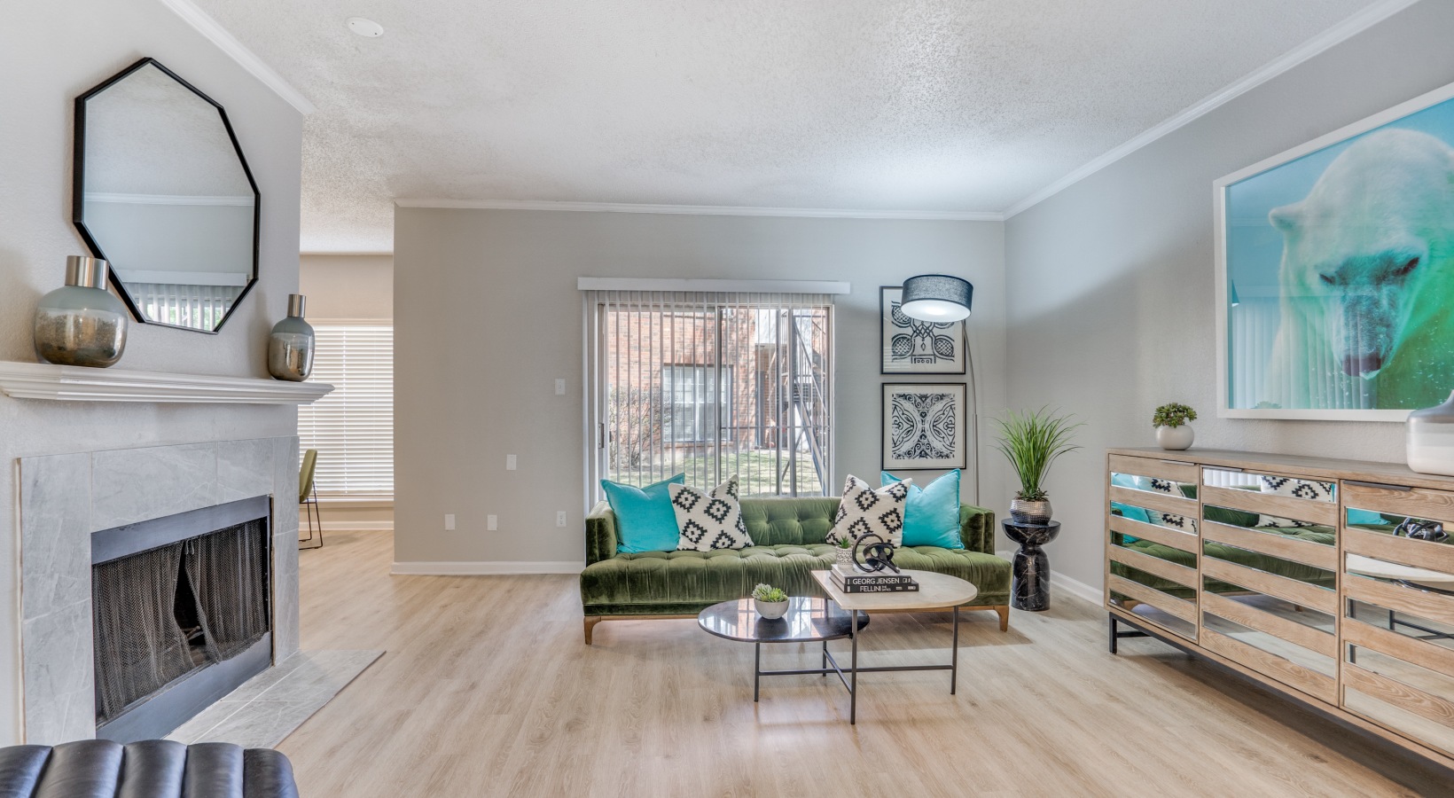 a living room with a fireplace and a couch at The  Hathaway at Willow Bend