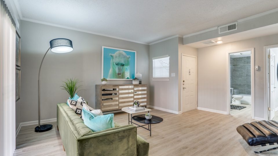 a living room with a couch, coffee table and television at The  Hathaway at Willow Bend