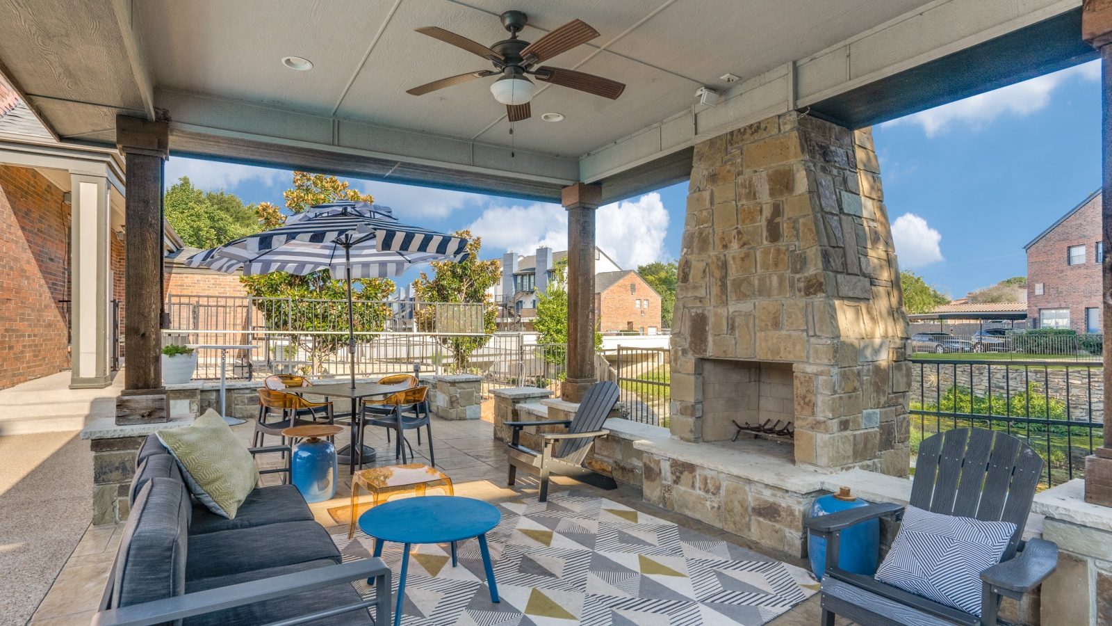 a patio with a fireplace and seating area at The  Hathaway at Willow Bend