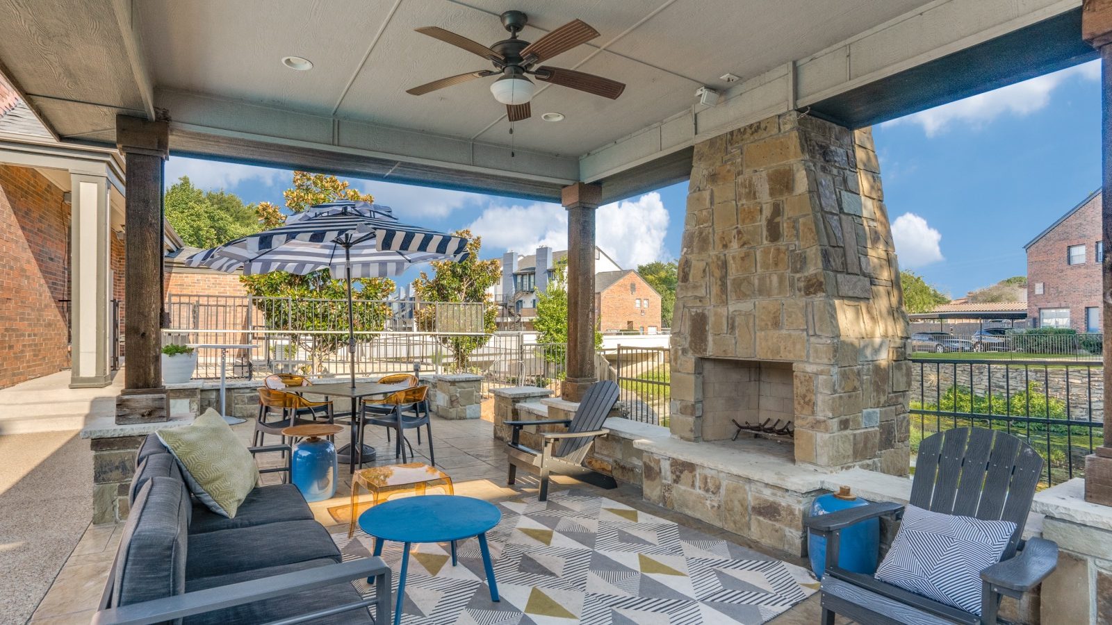 a patio with a fireplace and seating area at The Hathaway at Willow Bend